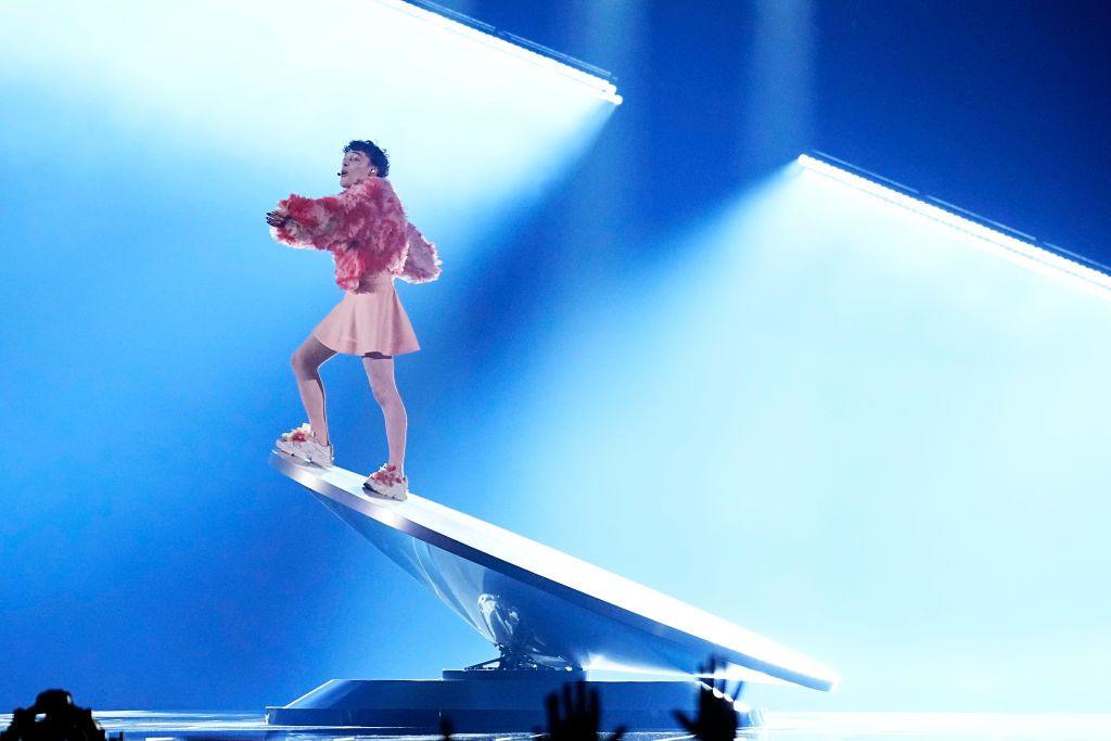 Nemo stands on a tilted rotating platform at the 2024 Eurovision Song Contest