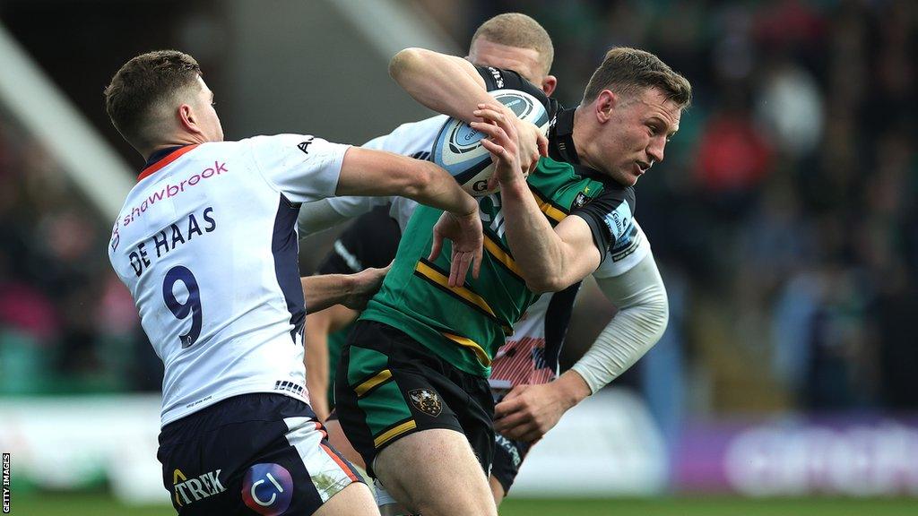 Fraser Dingwall of Northampton Saints is tackled by Ruben de Haas of Saracens