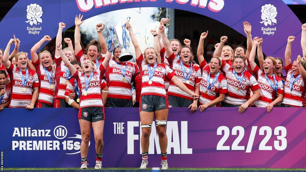 Gloucester-Hartpury players lift the trophy and celebrate