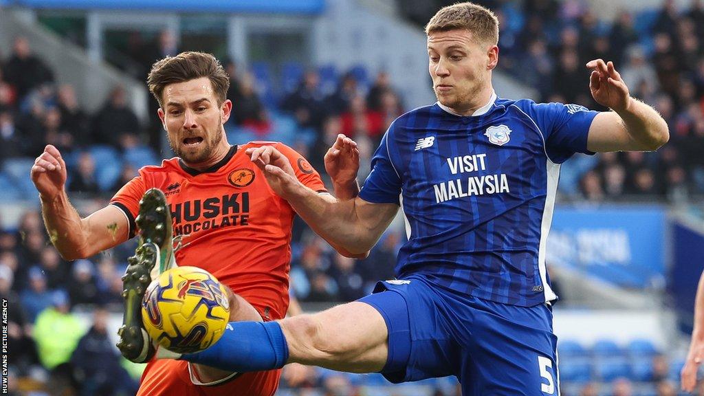 Mark McGuinness (right) challenges for the ball