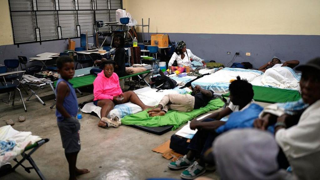  People take shelter in a school ahead of Hurricane Melissa's forecast arrival in Old Harbour, Jamaica
