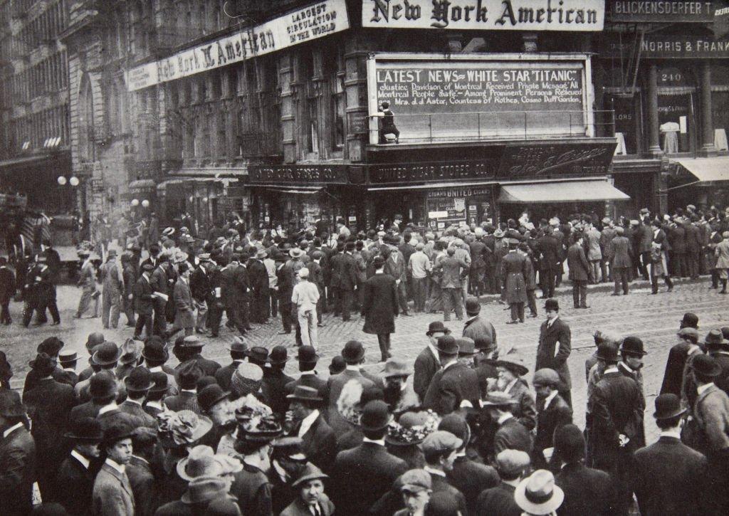 As the reports of the disaster arrived in New York, April 1912, people gathered around newspaper bulletin boards