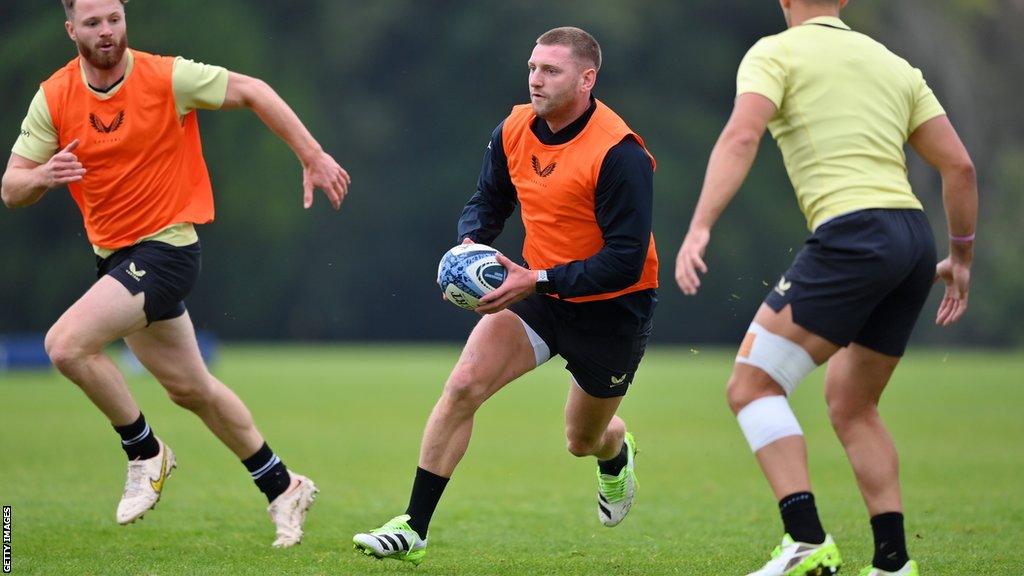 Finn Russell (centre) runs with the ball during a training session for Bath