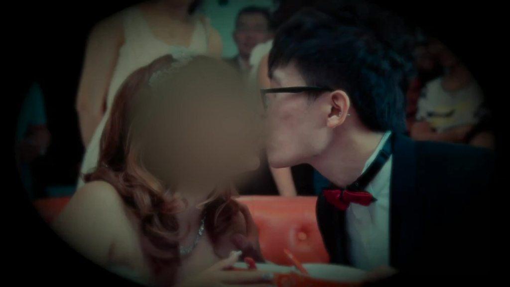 Married couple kissing (woman's face obscured)