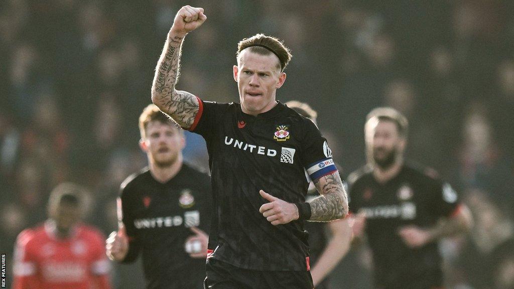 Wrexham's James McClean celebrates scoring a goal