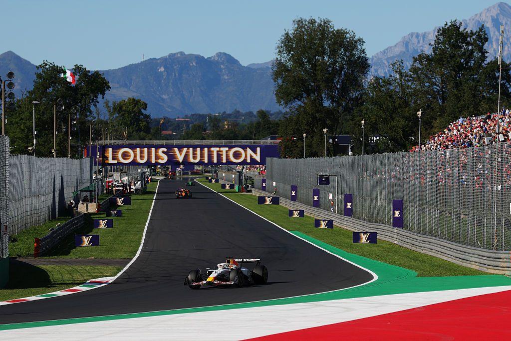 The Racing Bulls of Isack Hadjar heads into the Parabolica corner at Monza during practice for the Italian Gand Prix. Mountains can be seen in the background
