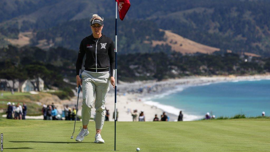 England's Charley Hull walking across a green at Pebble Beach