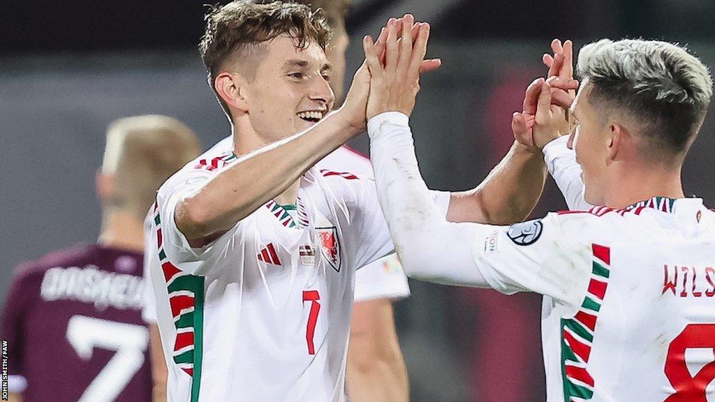 David Brooks and celebrates with Harry Wilson