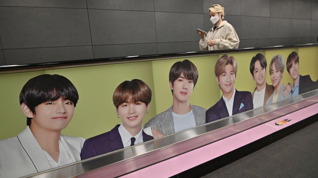 BTS advertising on the side of an escalator.