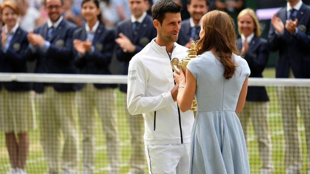 Novak Djokovic accepts the trophy from the Duchess of Cambridge