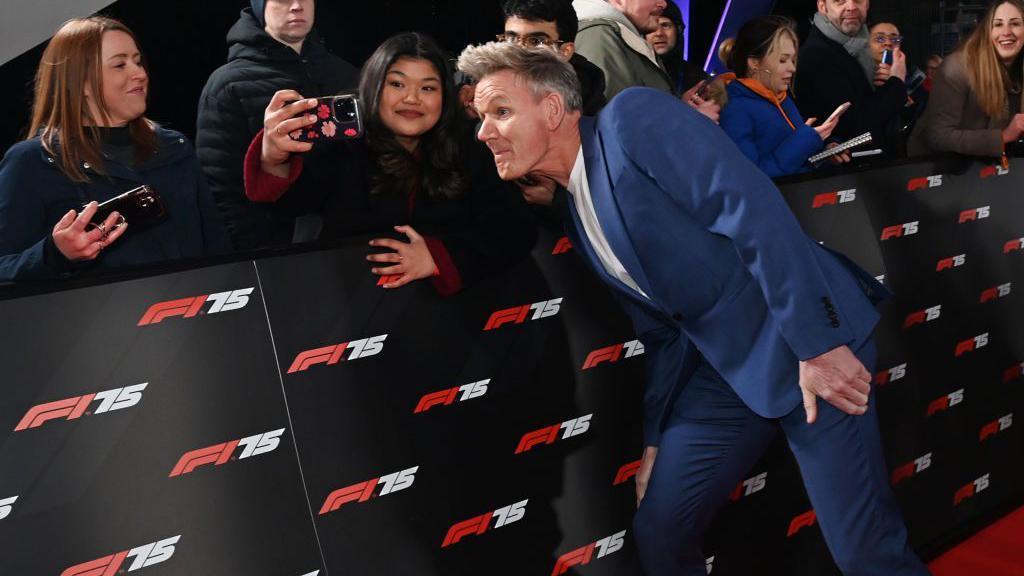 Gordon Ramsay poses for a selfie on the red carpet