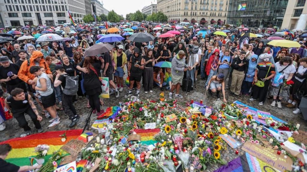 People gather at Brandenburg Gate, after a deadly incident in which a vehicle crashed into a crowd near Berlin's annual Christopher Street Day Pride parade