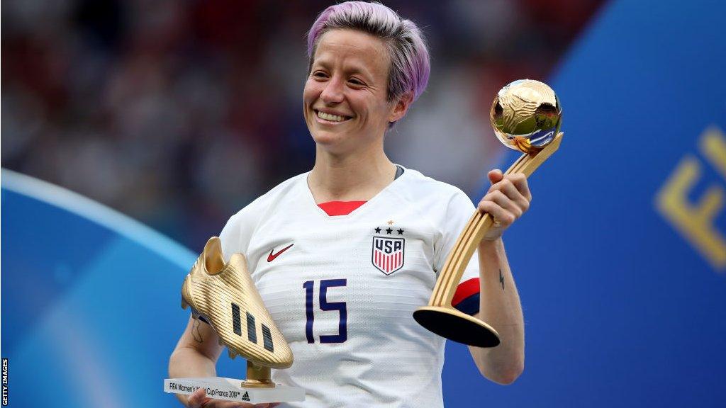 Megan Rapinoe holds the Golden Boot and Golden Ball awards