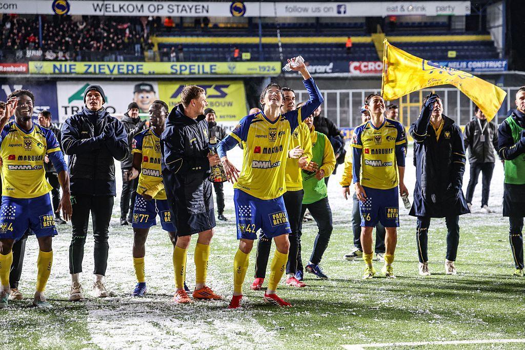 Sint-Truiden players celebrate after the final whistle after securing a victory against Zulte Waregem