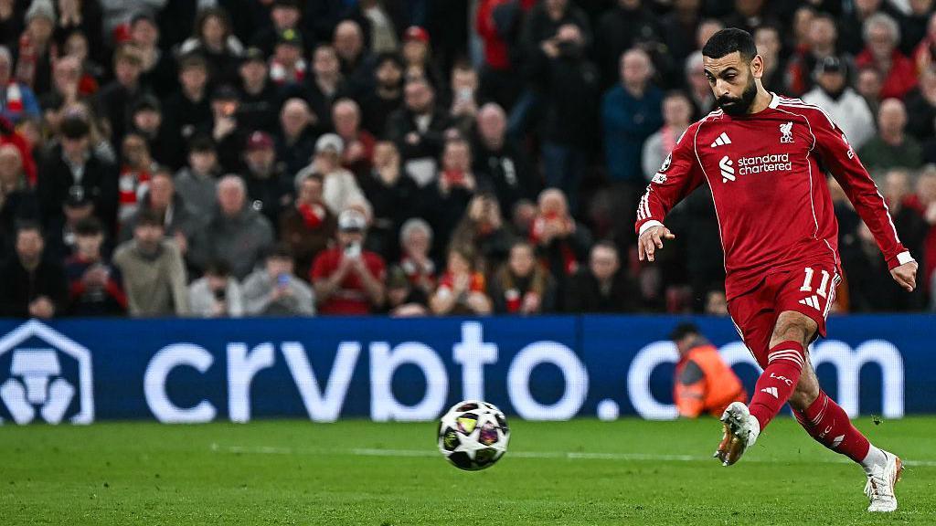 Mo Salah kicks a ball on the pitch