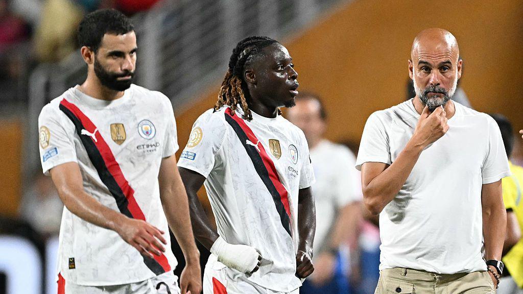 Rayan Ait-Nouri, Jeremy Doku and Pep Guardiola look dejected