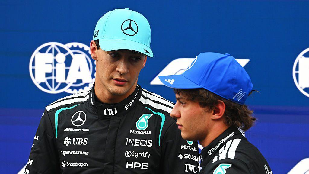 George Russell and Kimi Antonelli stand together after qualifying 
