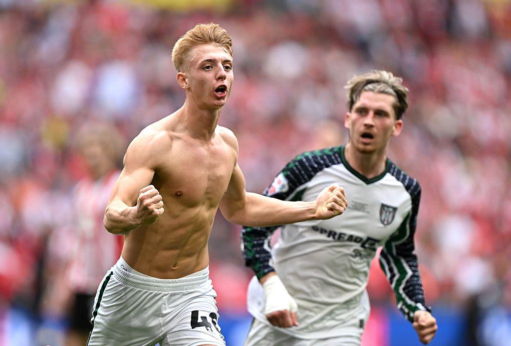 Tommy Watson celebrates scoring a 95th-minute winner.