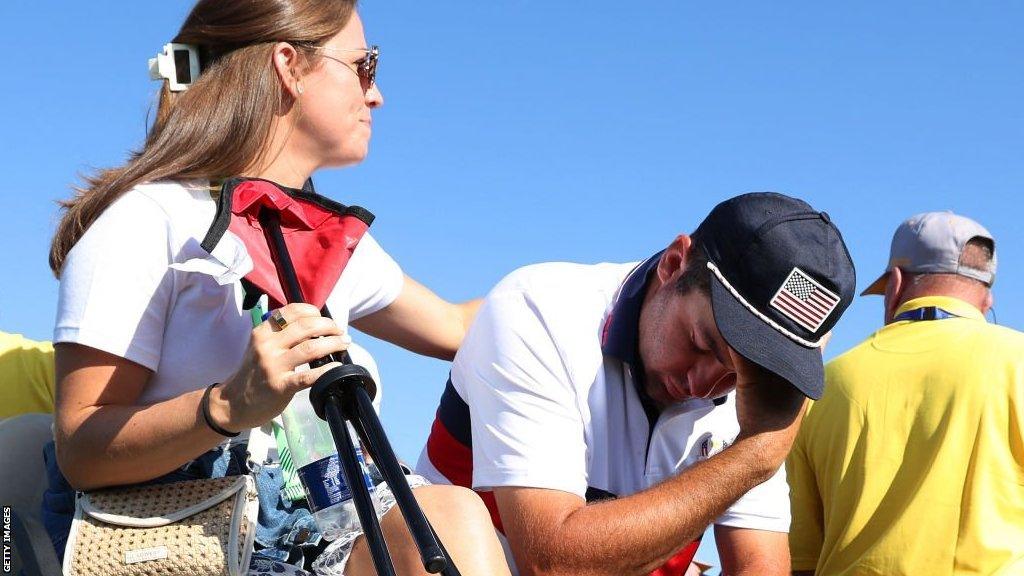 Scottie Scheffler being consoled by his wife Meredith