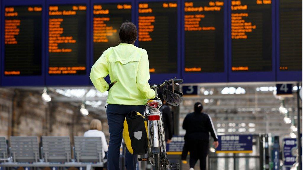 Passenger looks at arrivals board