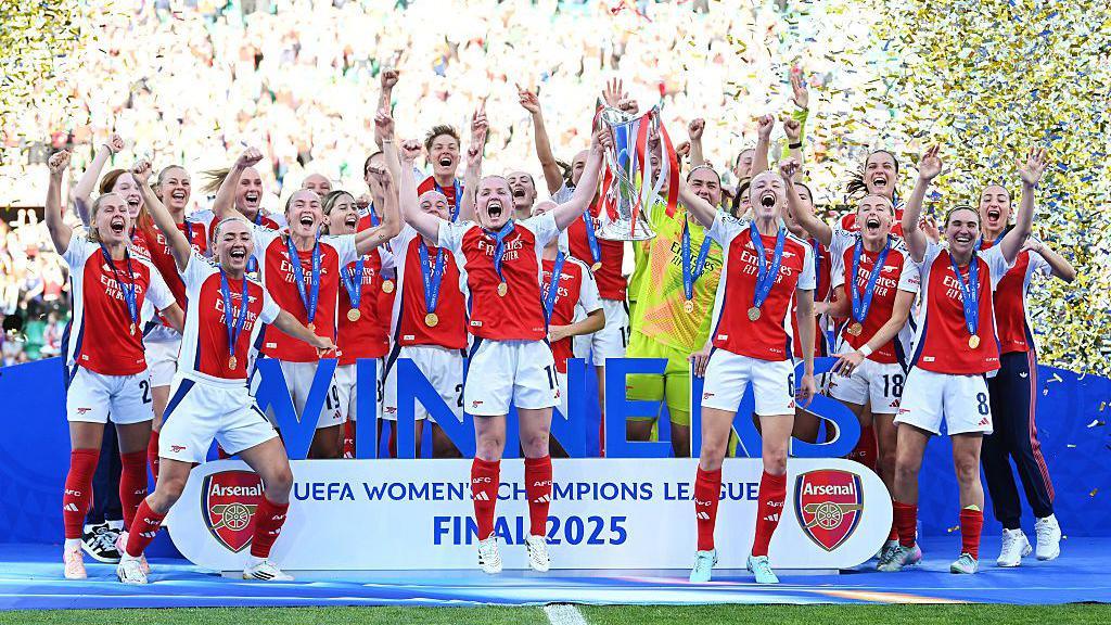 Arsenal Women lifting the Champions League trophy in 2025.