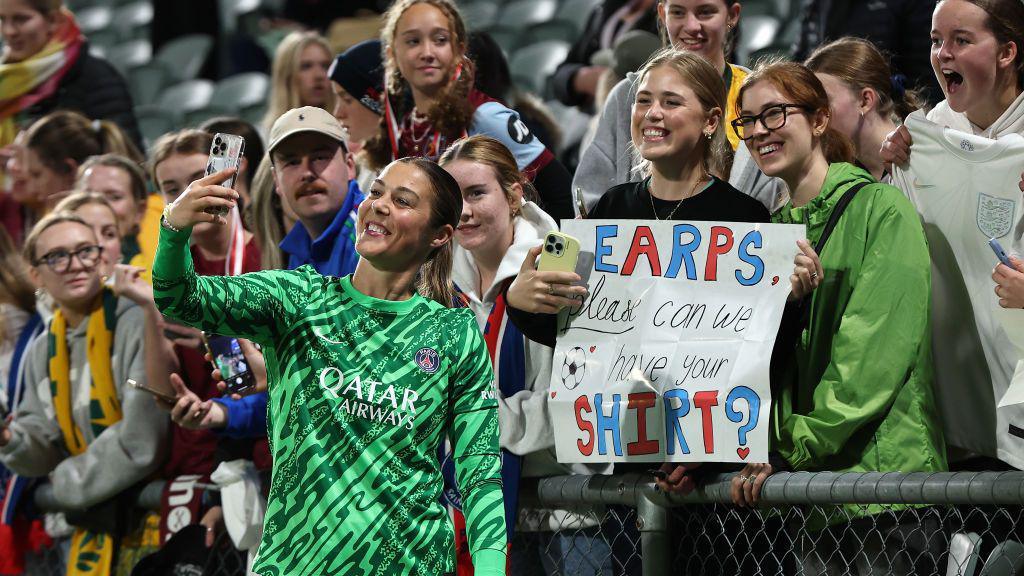 Mary Earps taking a selfie with fans.