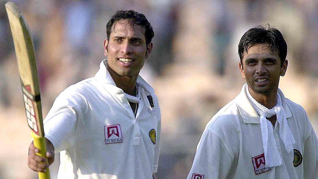 Indian batsman Venkat Sai Laxman (L) points his bat towards the cheering crowd as team-mate Rahul Dravid looks on as they walk back to the pavillion on the fourth day of the second test match between India and Australia at Eden Gardens in Calcutta 14 March 2001. 