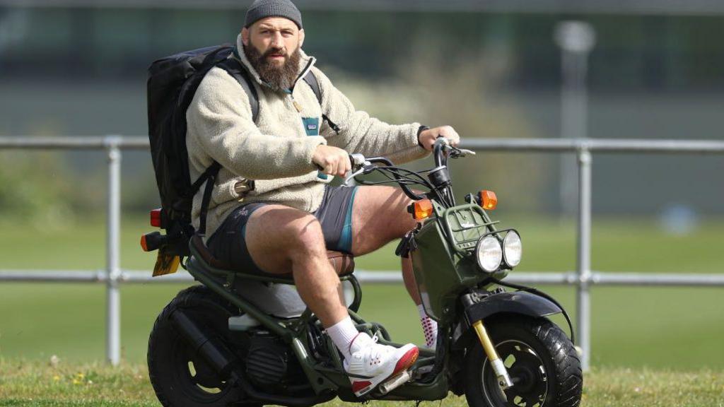 Marler arrives at Harlequins training at Surrey Sports Park, in Guildford, on a scooter.