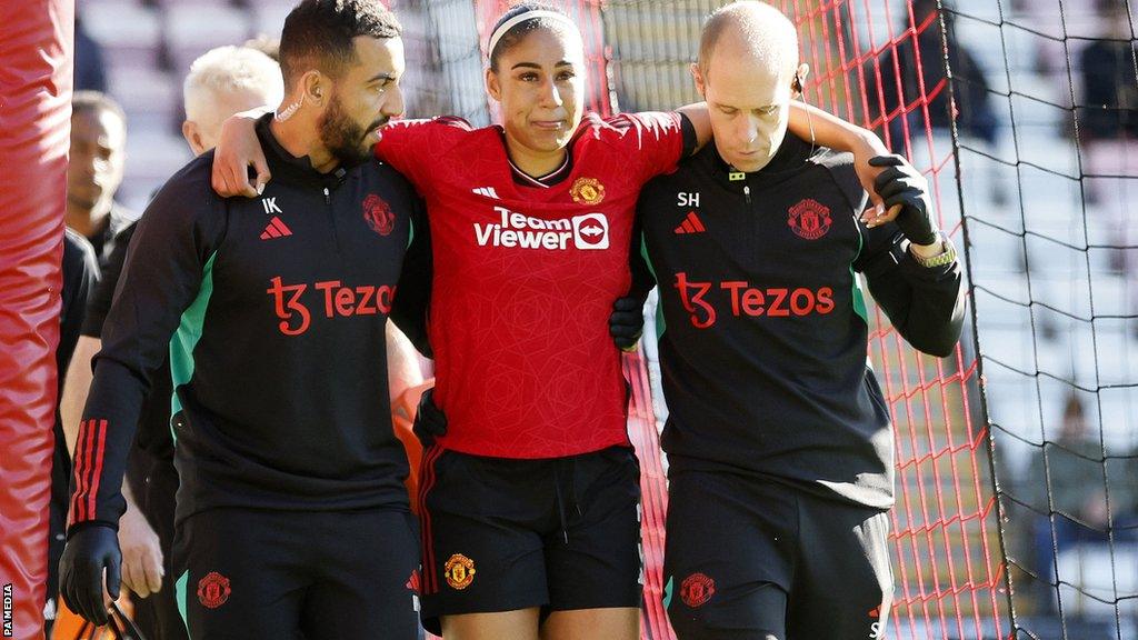 Manchester United defender Gabby George is taken off injured against Leicester