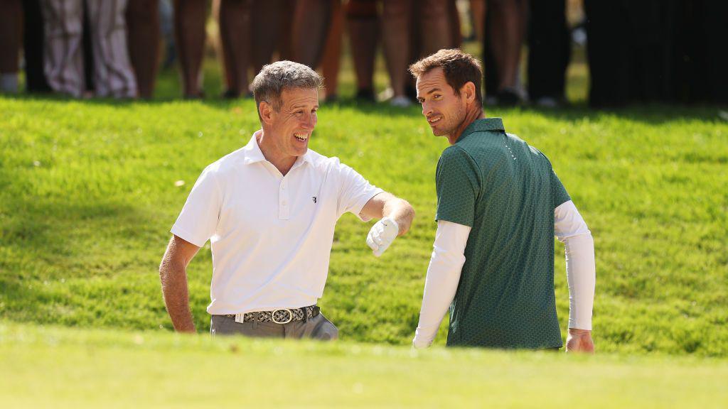 Anton Du Beke and Sir Andy Murray play golf on an overcast day.