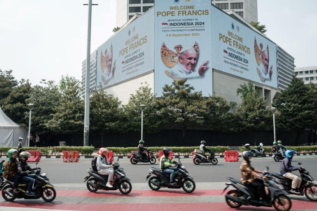 A welcome message for Pope Francis is displayed on an electric billboard at a roundabout in Jakarta