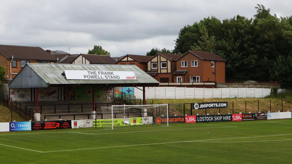 A view of Chorley's Victory Park ground showing a covered terrace behind a goal