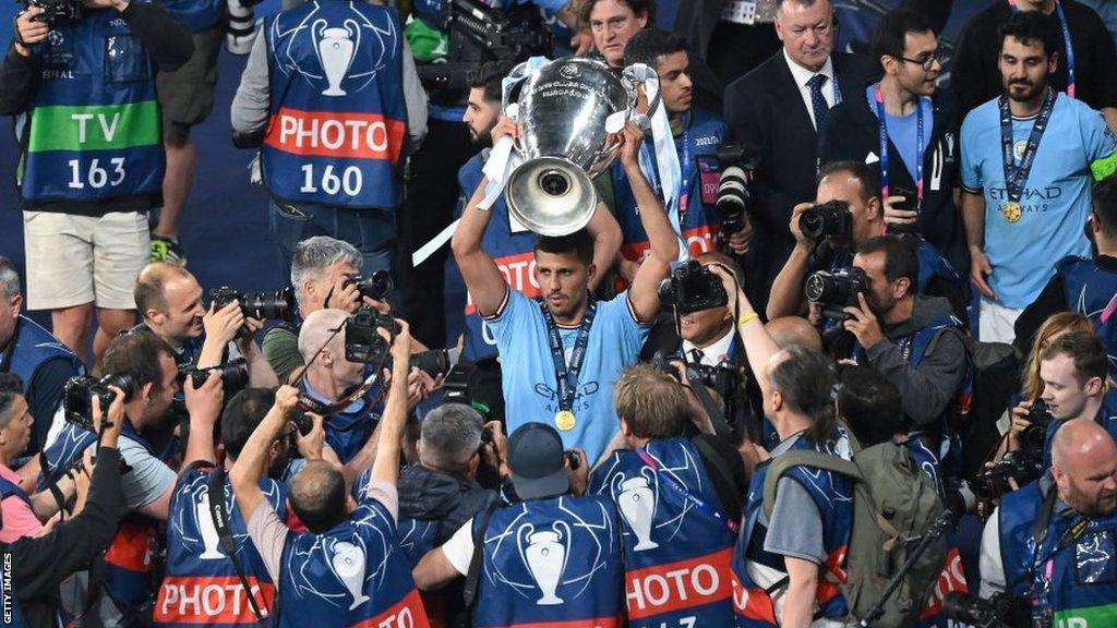 Manchester City's Rodri with Champions League trophy