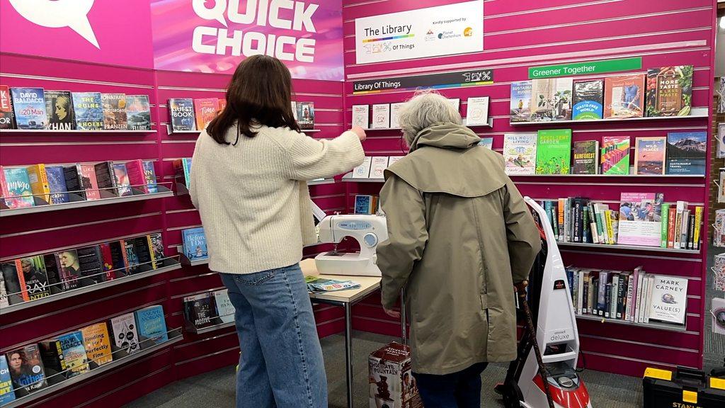 Two people looking at the Library of Things