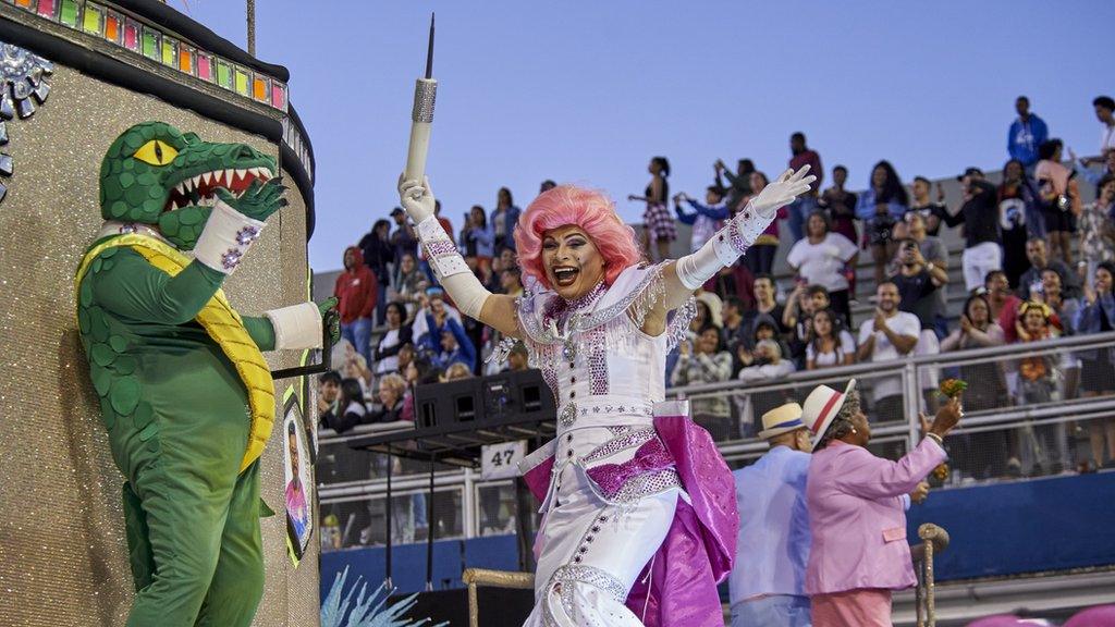 A person dressed as a crocodile and another as a nurse holding a big syringe