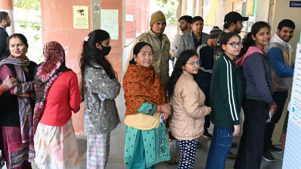 People cast their vote at a booth centre at Pochanpur Village in South West Delhi, on February 5, 2025 in New Delhi, India. 