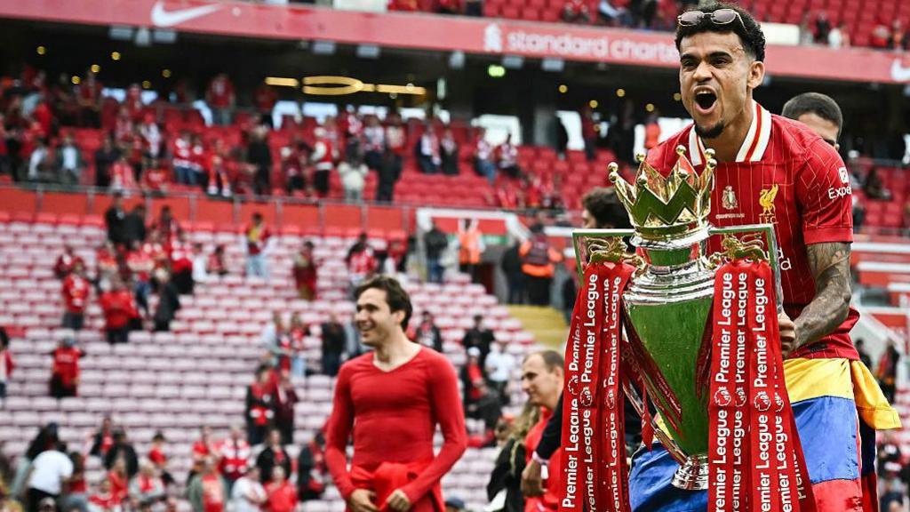 Luis Diaz celebrating with the Premier League trophy