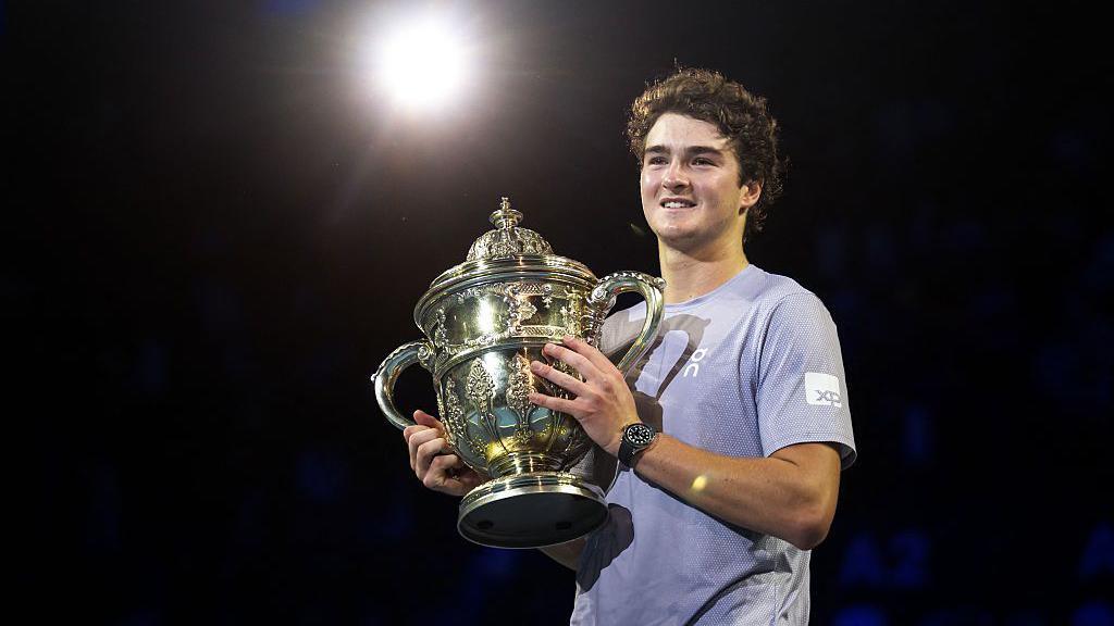Brazil's Joao Fonseca poses with the Swiss Indoors trophy