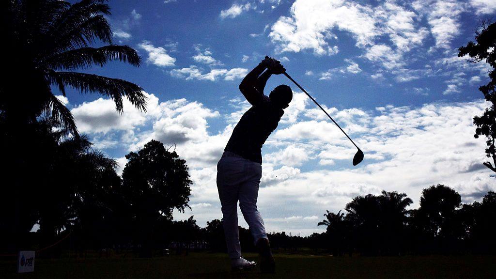 Silhouetted golf player in Thailand