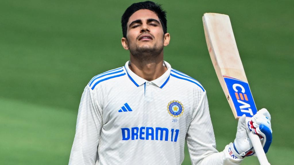 India batter Shubman Gill raises his bat to celebrate hitting a century