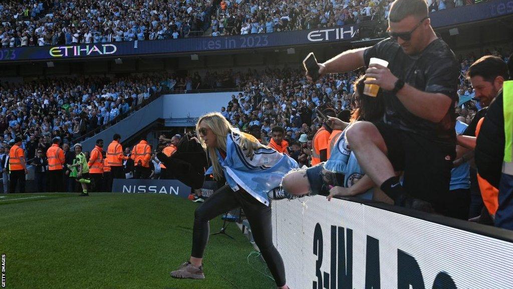 Manchester City fans run onto the pitch at full time in their 1-0 win against Chelsea