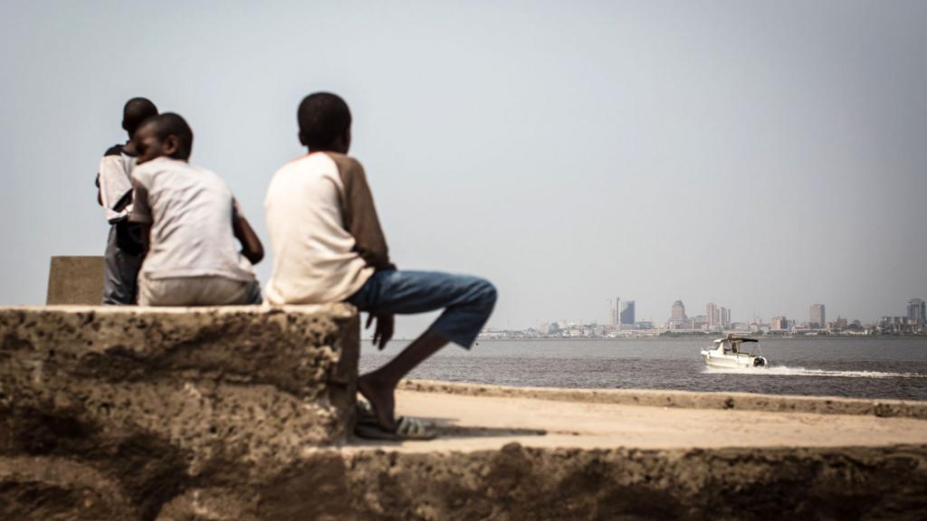 A group of children sit on the shores of the Congo river in Brazzaville, July 2015