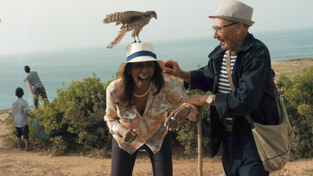 Zeinab Badawi with a falcon on her head