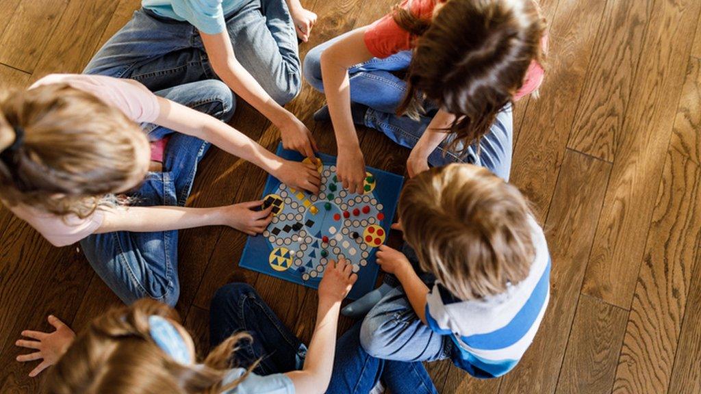 CHILDREN PLAYING BOARD GAME