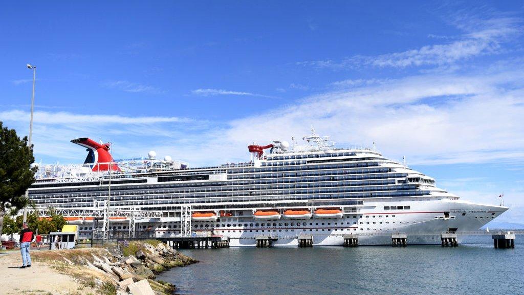 Travellers trying to board the Carnival Panorama cruise ship for a 7 day trip were met with a delay in Long Beach, US.