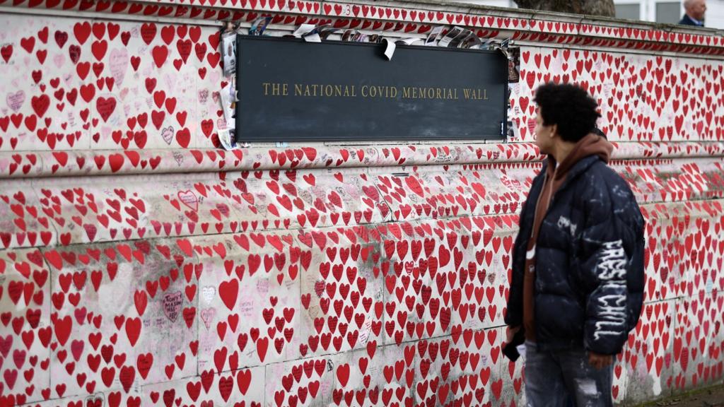 A man walks past the National Covid memorial