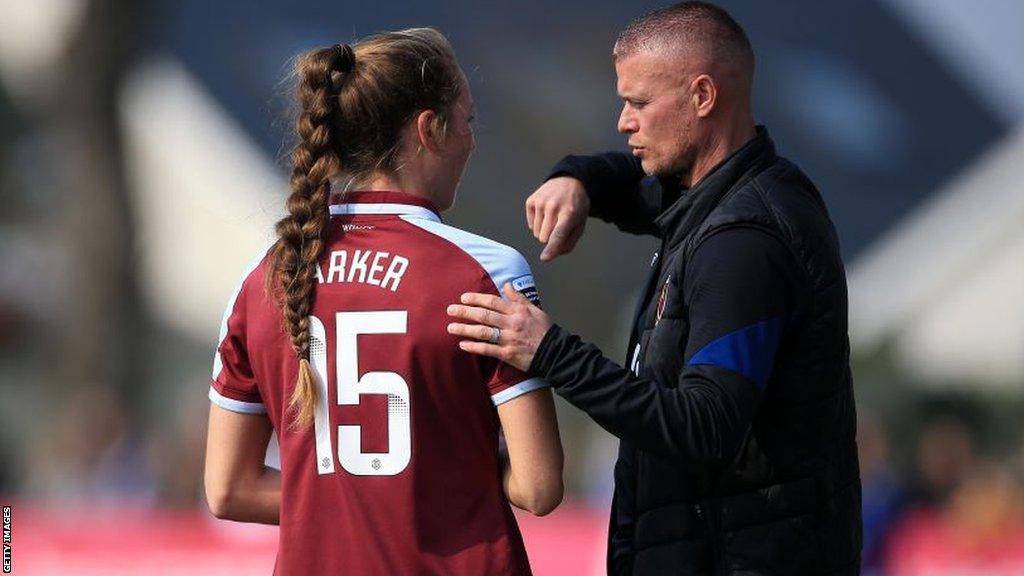 Paul Konchesky talks to player Lucy Parker at a West Ham game