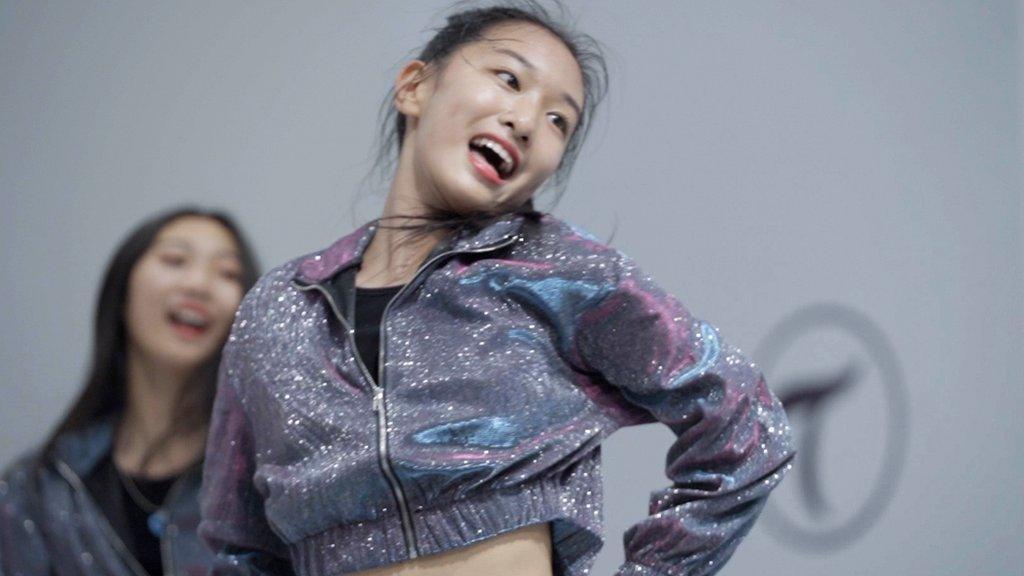 12-year-old idol trainee Yang Jingxin is at a dance training session with her agency.