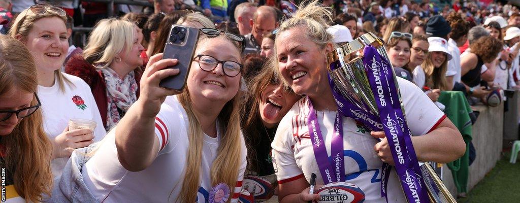 Marlie Packer takes a selfie with a fan and the Women's Six Nations trophy