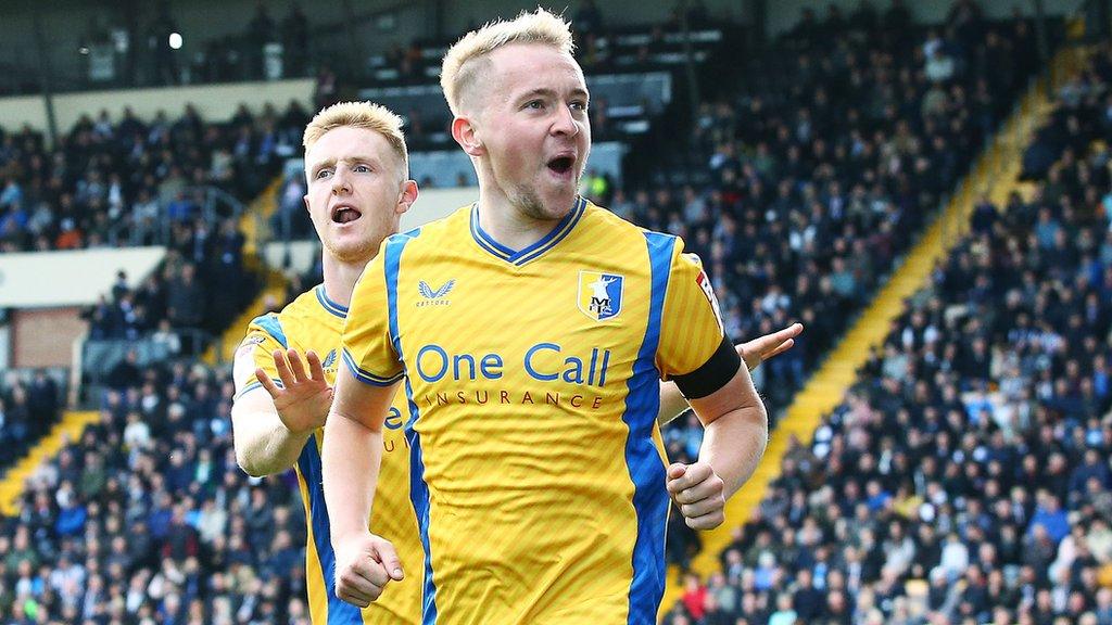 Louis Reed of Mansfield Town celebrates scoring against Notts County